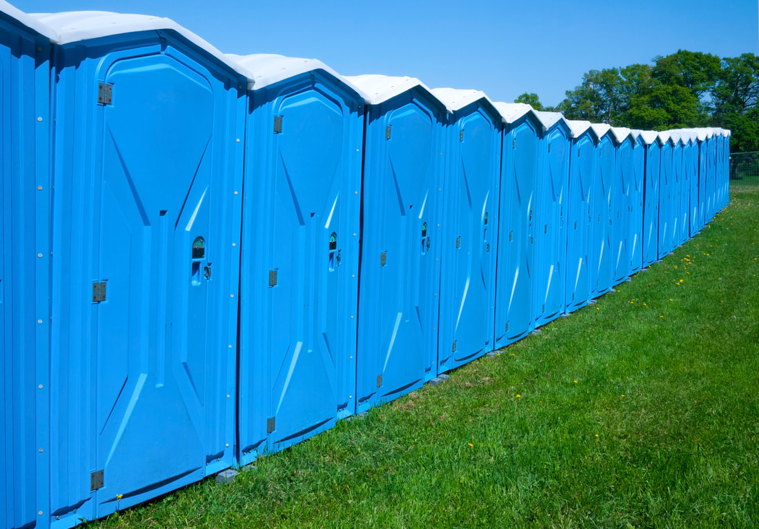 portable toilets in the grass